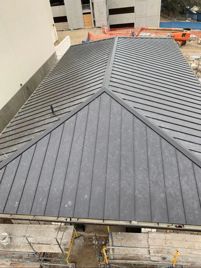Commercial metal roof construction with crane equipment in Webb City