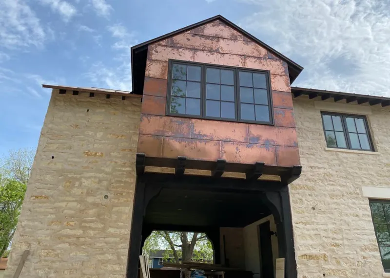 Copper metal panel facade on a stone building for Metal Roof Coating in Webb City