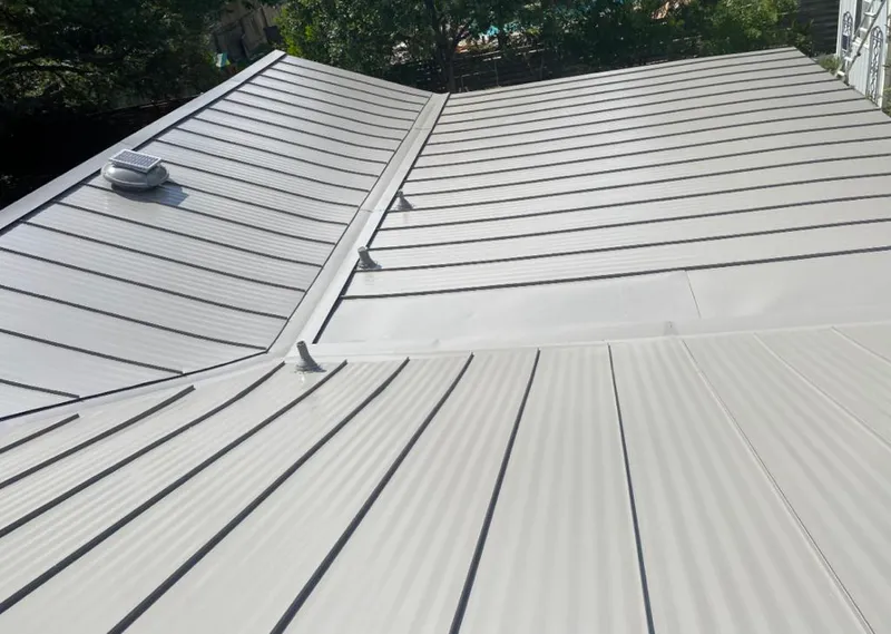 Solar attic fan installed on a metal roof for Roof Ventilation in Webb City